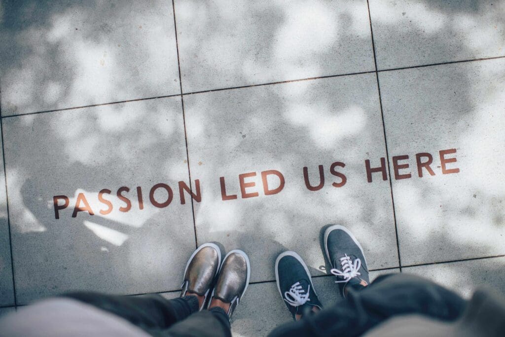Two people standing on a tiled floor with the words " passion led us here ".